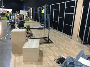 A raised platform installed at The Furniture Show, complete with wood laminate vinyl floor covering.