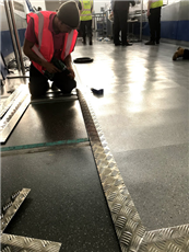 Qik-Link raised platform installed at Stansted Airport, finished with a chequer plate ramped edge.